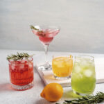 Four,Colorful,Summer,Cocktails,In,Glasses,On,White,Table.,Assortment